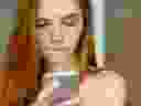 Closeup of a beautiful redhead woman looking at smartphone.