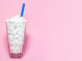 A cup filled with cubes of a sugar-like substance.