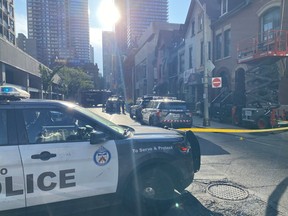 Toronto Police at the scene of a double shooting on Charles St. in Toronto on Monday, July 10, 2023.