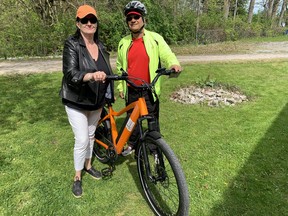 Laura Alderson gets fitted for her electric bike before a Niagara-on-the-Lake winery tour with guide Fernando Gonzales. (Jane Stevenson/Toronto Sun)