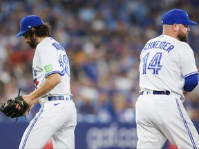 Jordan Romano (left) of the Toronto Blue Jays leaves the mound as he's pulled by manager John Schneider in the ninth inning against the Los Angeles Angels at Rogers Centre on July 28, 2023 in Toronto.