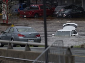Abandoned cars in a mall parking lot are seen in floodwater following a major rain event in Halifax