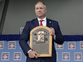 Scott Rolen poses for a photograph with his plaque during the Baseball Hall of Fame induction ceremony at Clark Sports Center