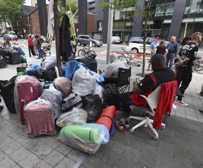 Asylum-seeking refugees who have come to Canada from African nations like Uganda, Kenya, Nigeria and Tanzania are camped out outside the Peter St. city-run facility for homeless on Thursday, July 13, 2023.