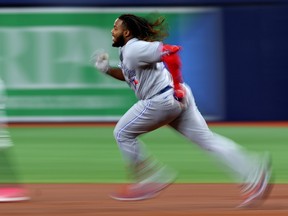 Vladimir Guerrero Jr. is blurred as he runs