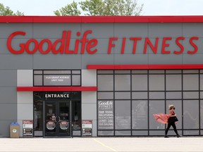 A woman walks past a GoodLife Fitness gym. Postmedia photo