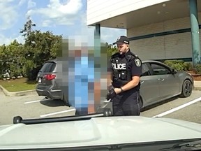 Blurred image of man being arrested for impaired driving