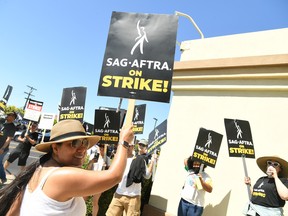 Members and supporters of SAG-AFTRA and WGA walk the picket line