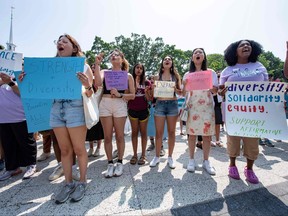 Proponents of affirmative action hold signs during a protest at Harvard University in Cambridge
