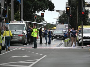 Police officers cordon off the site of a shooting in central Auckland on July 20, 2023.
