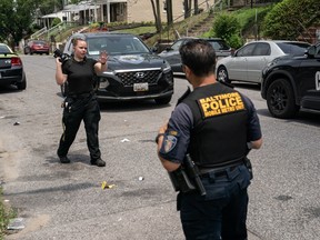 Baltimore Police investigate the site of a mass shooting