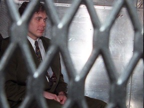 Paul Bernardo arrives at the provincial courthouse in the back of a police van in Toronto in a November 3, 1995 file photo. The federal Conservatives say Canadians angry over Bernardo's move to a medium-security prison have a Liberal government law to blame.