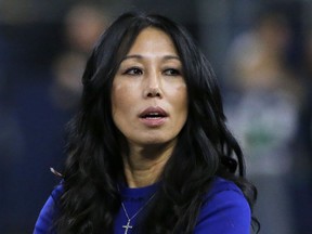 FILE - Buffalo Bills co-owner Kim Pegula stands on the field before an NFL football game in Arlington, Texas, Nov. 28, 2019. Bills co-owner Pegula watched training camp practice from the front seat of the family's SUV on Sunday, July 30, 2023, in making an encouraging first public appearance in 14 months since experiencing a debilitating cardiac arrest.