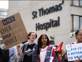 Junior doctors hold placards at a picket line outside St. Thomas' Hospital in London