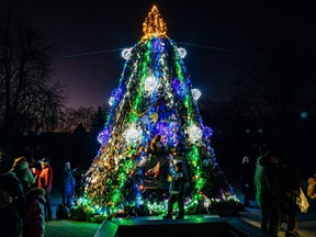A Christmas tree made of camouflage nets draws a small crowd in Mykolaiv, on Dec. 19, 2022