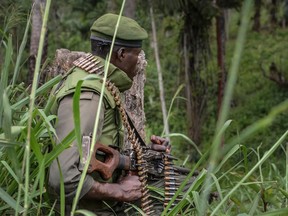 In this Jan. 25, 2018 file photo, a soldier of the FARDC (Armed Forces of the Democratic Republic of the Congo) takes position during exchanges of fire with members of the ADF (Allied Democratic Forces) in Opira, North Kivu.