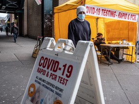 A person wearing a mask walks past a coronavirus testing tent in New York on March 3.