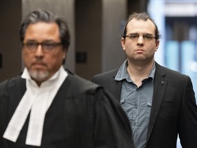 Gabriel Sohier-Chaput follows his lawyer as he arrives for sentencing in Montreal, Wednesday, July 12, 2023. Sohier-Chaput was found guilty in January of promoting hatred against Jews in connection with an article he wrote for the neo-Nazi website the Daily Stormer.