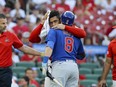 St. Louis Cardinals catcher Willson Contreras embraces Chicago Cubs' Ian Happ as Contreras leaves the game after being hit by Happ's bat during the first inning of a baseball game Thursday, July 27, 2023, in St. Louis.