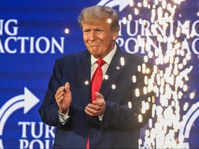 Former U.S. president and 2024 presidential hopeful Donald Trump applauds after speaking at the Turning Point Action USA conference in West Palm Beach, Fla., on July 15, 2023.