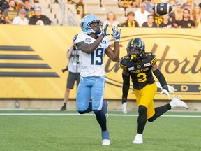 Argonauts wide receiver Kurleigh Gittens Jr. (19) makes a touchdown catch while defended by Tiger-Cats defensive back Tunde Adeleke (2) during first half CFL action in Hamilton, Ont., Friday, July 21, 2023.