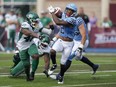 Argonauts' Javon Leake, right, breaks a tackle before running into the end zone for a touchdown during the first half of CFL action against the Saskatchewan Roughriders in Halifax on Saturday, July 29, 2023.