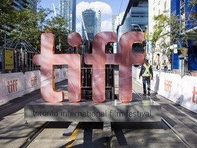 The Toronto International Film Festival is still more than a month away, but a pair of U.S. entertainment worker strikes have Hollywood North worried the annual event won't be its usual boon for local businesses. A sign bearing the Toronto International Film Festival logo is carried on a fork lift in downtown Toronto on Thursday September 7, 2017.