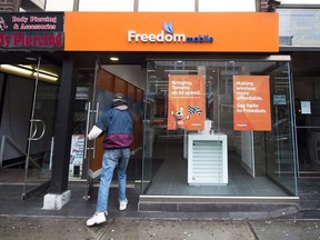 A man enters Freedom Mobile store in Toronto on Thursday, November 24, 2016.