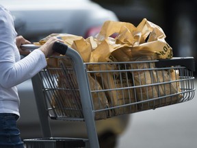A women leaves a grocery in Mississauga, Ont., Thursday, Aug. 15, 2019. Canadians eligible for the GST credit are expected to receive a special payment today to help with the rising cost of groceries.