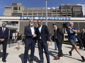 Minister of Transport Omar Alghabra, and Minister of Canadian Heritage Pablo Rodriguez, shake hands on the rail platform outside Central Station prior to a press conference in Montreal, Thursday, July 20, 2023.