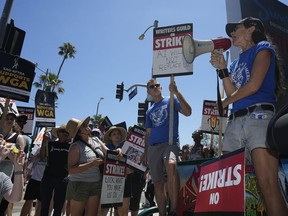 Justine Bateman, right, speaks outside Netflix during a Writers Guild rally