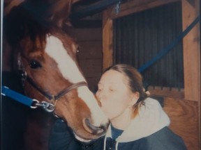 Karina Courtmanche giving Bella a kiss in the 1990s.