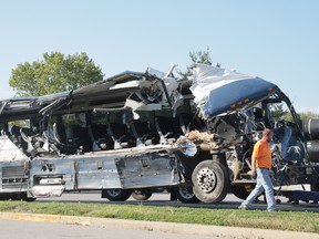 wreckage of a Greyhound bus that collided with tractor-trailers