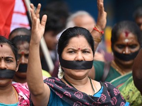 Demonstrators with black strips covering their mouths