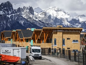 Mt. Rundleis seen behind homes being constructed in Canmore, Alta.