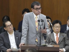 Japan's Digital Minister Taro Kono, center, speaks during a parliamentary session in Tokyo, on July 5, 2023. The minister charged with an overhaul of Japan's digitized system to assign a number to everyone living in the country has apologized, as doctors protested over glitches with health insurance and local governments begged for clarity on how to handle the problems.(Kyodo News via AP)