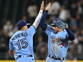 Whit Merrifield, left, and George Springer of the Toronto Blue Jays celebrate after defeating the Chicago White Sox 5-4 in game two
