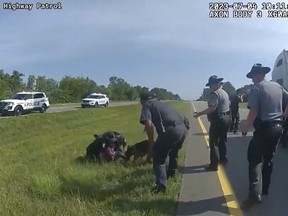 This image taken from police body cam video shows a police dog attacking Jadarrius Rose, 23, of Memphis, Tenn., on Tuesday, July 4, 2023, in Circleville, Ohio.