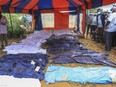 FILE - Body bags are laid out at the scene where dozens of bodies have been found in shallow graves in the village of Shakahola, near the coastal city of Malindi, in southern Kenya on April 24, 2023. The number of people who died in connection with Kenya's doomsday cult has crossed the 400 mark as detectives exhumed 12 more bodies on Monday, July 18, 2023, believed to be followers of a pastor who ordered them to fast to death in order to meet Jesus. Pastor Paul Mackenzie, who is linked to the cult based in a forested area in Malindi, coastal Kenya, is in police custody, along with 36 other suspects. All have yet to be charged. (AP Photo)