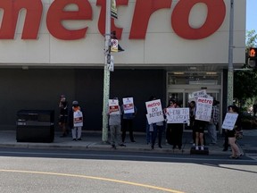 Striking workers are pictured at a Metro grocery store near Bloor St. W. and Spadina Rd. on July 30, 2023.