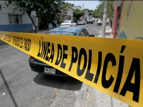 forensic personnel work at the crime scene of a clandestine grave located inside a house in Guadalajara, Jalisco State