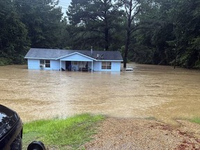 In this image provided by Mississippi state Rep. Michael Evans, floodwaters surround a home in Louisville