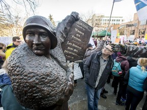 In this file photo, a statue of activist Nellie McClung, part of the Women are Persons! Famous Five sculpture, stands during the Calgary Women's March in downtown Calgary