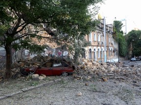 This photograph taken on July 23, 2023, shows a car under the rubble of a building damaged following a missile strike in Odesa, amid the Russian invasion of Ukraine.