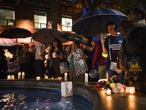 People look on during a memorial for the victims and survivors of the 2018 Danforth shooting during a community vigil held in Toronto on Monday, July 22, 2019. Survivors of the Danforth shooting and their families are expected to be among those who gather today to mark five years since the deadly attack in Toronto's Greektown neighbourhood.