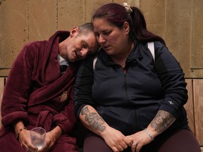 Kevin Ackroyd sits on the patio at Kensington Hospice with his housing worker and close friend Starr Dedam, in Toronto, Tuesday, June 6, 2023. Ackroyd, who was previously in a shelter hotel for the unhoused, moved to the hospice as the hotel was closing and faced living on the street while dying of liver cancer.