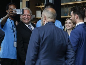 Premier Doug Ford poses for photos with staff.