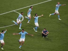 Manchster City players celebrate their 1-0 win at the end of the Champions League final soccer match between Manchester City and Inter Milan at the Ataturk Olympic Stadium in Istanbul, Turkey, Saturday, June 10, 2023.