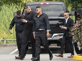 Friends of Hells Angels' Allie Grewal, aka Ali Grewal attend his funeral service in Delta, BC, August, 16, 2019. Harb Dhaliwal is in the middle, with arms straight down, and on the right, also wearing sunglasses, is accused killer Tyrel Nguyen Quesnelle.