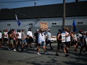 Striking International Longshore and Warehouse Union Canada workers march from the port to a rally, in Vancouver